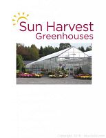 Photo of Sun Harvest Greenhouses building exterior with colorful flower pots displayed outside.