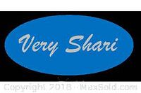 Photo of the Very Shari blue oval logo on a solid black background.