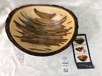 Top-down view showing natural bark live edge and interior wood grain with dark streaks.