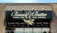 Signage of Bread & Butter Bakery and Fine Pastries, showing the bakery name and types of products offered such as breads, pies, cakes, and home meals.
