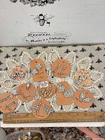 All ten earring pairs on tags with ruler for scale