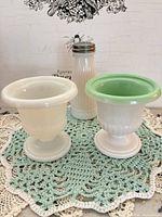 Front view showing both pedestal urns and ribbed shaker