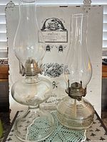 Both pressed glass hurricane lamps side by side showing overall form and chimneys