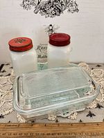 butter dish with lid, two milk glass shakers, ruler for scale