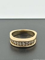 Top view of yellow gold ring with channel-set diamonds