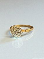 Side perspective of gold band and diamond cluster