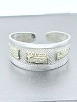 Front view of the open-back silver band with gold panels