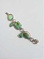 Full view of bracelet showing turquoise cabochons and silver links