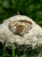 Front view of ring showing heart motif and diamond