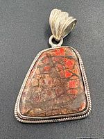 Front view showing Ammolite coloration and silver bezel