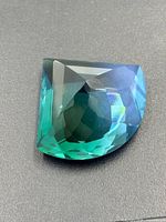 Oblique view of faceted bi-colour gemstone