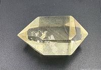 Top view of transparent pale yellow citrine crystal showing double termination and inclusions