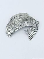 Front view of carved sterling silver salmon brooch/pendant