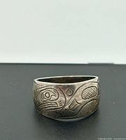 Front view of engraved sterling silver ring showing formline art