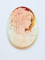 Front view of cameo showing carved female profile and color contrast