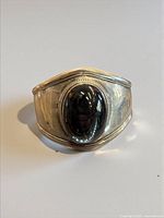 Front view showing obsidian cabochon and cuff shape