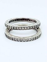 Two stacked sterling eternity rings with clear stones