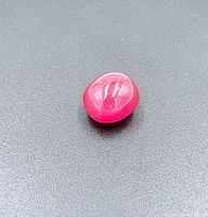 Ruby cabochon gemstone on black background
