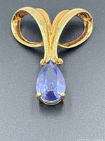 Front view showing brooch design and blue gemstone