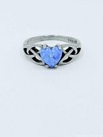 Front view showing Celtic knot design and heart-shaped blue opal stone