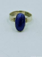 Front view of sterling silver ring with blue enamel cabochon