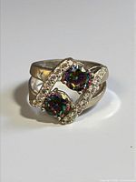 Front view showing twin mystic topaz stones and accent stone rows