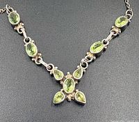 Close-up of necklace showing peridot stones and silver setting