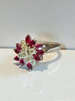 Ring angled view showing cluster of rubies and clear stones