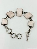 Full view of bracelet displaying five shell inlay links and toggle clasp