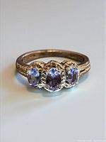 Top view of sterling silver ring with three tanzanite stones
