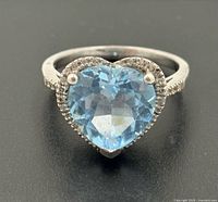 Front view showing heart-cut blue topaz and halo