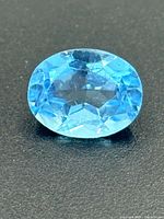 Top view of oval blue topaz showing clarity and faceting
