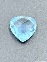Heart-shaped blue topaz on neutral background