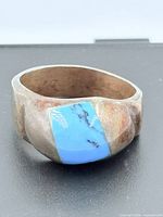 Front view of sterling silver ring showing turquoise inlay