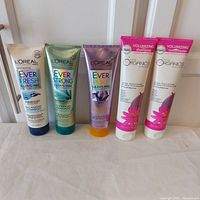 Five haircare tubes standing in a row