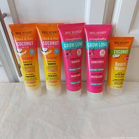 Five Marc Anthony hair care tubes standing in a row