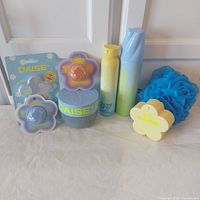 Group shot of all Daise body care items and bath puff
