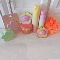 Group shot of all eight Daise bath & body items plus mesh puff