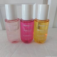 Front view of three Florence by Mills 150 ml hair & body mists