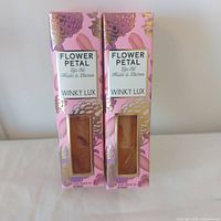Front view of two boxed Winky Lux Flower Petal Lip Oils