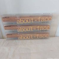 Three sealed About Face Shadowstick boxes stacked