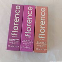 Front view of three boxed lip balms