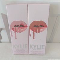 Front view of two Kylie Cosmetics lip kit boxes