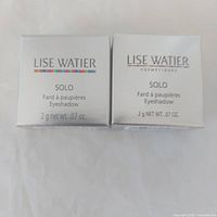 Front view of two Lise Watier Solo eyeshadow boxes