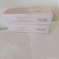 Two sealed PUR On Point Tint boxes stacked showing front labeling