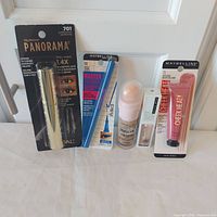 Group shot showing all five sealed cosmetic items