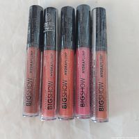 Front view of five sealed Annabelle Big Show Hydraplump lip gloss tubes