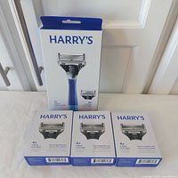Boxed Ocean razor handle with 2 cartridges and three boxes of 4-pack cartridges