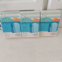 Front view of three boxed St Tropez Express Self Tan Kits