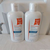 Front view of two sealed bottles showing labels